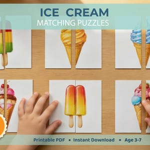 May include: A children's ice cream matching puzzle game featuring illustrations of ice cream cones and ice lollies. The image shows a child's hands matching the puzzle pieces. The text on the image says "Ice Cream Matching Puzzles", "16 Pairs (32 Pieces)", and "Age 3-7".
