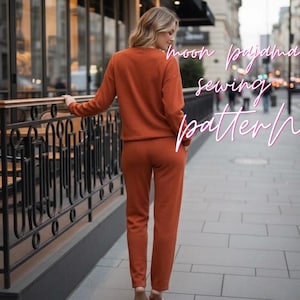 May include: A rust-colored long-sleeve top and matching pants set with a textured knit finish. The text "moon pajama sewing pattern" is overlaid in white script. The garment features a crew neckline, long sleeves, and straight-leg trousers.