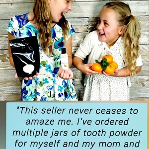 May include: Two girls smiling, holding products. One holds a black pouch with a white design, the other a small bottle and oranges. The background is a wooden wall. Text on the bottom praises the seller.