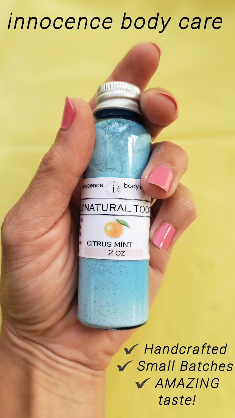 May include: A blue bottle of "SNATURAL TOOTH" citrus mint toothpaste, 57g, held in a hand. The label features an orange graphic. The text "innocence body care" is at the top. The bottle is labeled "Handcrafted", "Small Batches", and "AMAZING taste!"