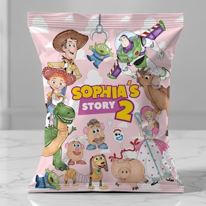 May include: A pink snack bag featuring a Toy Story character collage with Woody, Buzz Lightyear, Jessie, Rex, and others. The centre text reads Sophia's Story 2 in yellow and white lettering against a background of light pink clouds and blue sky.