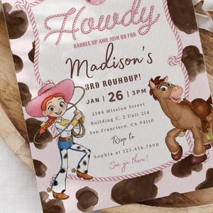 May include: A rectangular invitation card with a pink background featuring a brown cow print border. The text reads Howdy, Saddle up and join us for Madison's 3rd Roundup, Jan 26, 3pm, 2584 Mission Street, and Rsvp to Sophia at 123.456.7890.