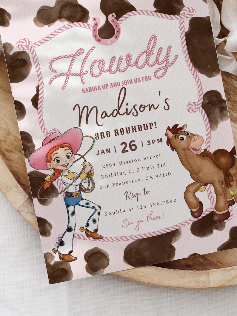 May include: A rectangular invitation card with a pink background featuring a brown cow print border. The text reads Howdy, Saddle up and join us for Madison's 3rd Roundup, Jan 26, 3pm, 2584 Mission Street, and Rsvp to Sophia at 123.456.7890.