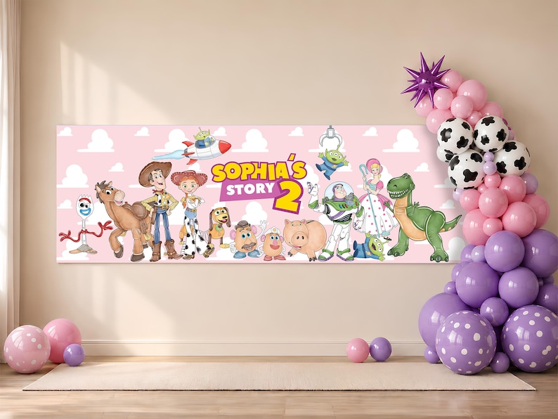 May include: A rectangular horizontal banner with a light pink background featuring the text "SOPHIA'S STORY 2" and various animated toy characters including a cowboy, cowgirl, space ranger, dinosaur, pig, and aliens, accented by a balloon arch.