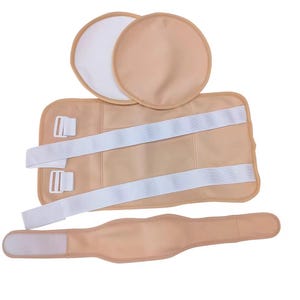 May include: A beige medical support brace set, including a rectangular back support with white straps and buckles, two round pads, and a curved waist support. The set is designed for medical use and is made of a soft, flexible material.