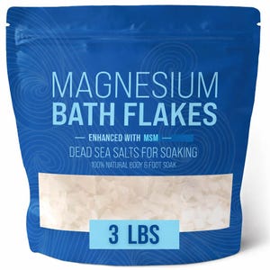May include: A blue bag of magnesium bath flakes. The bag has the words "MAGNESIUM BATH FLAKES" in large white letters. The bag also says "ENHANCED WITH MSM" and "DEAD SEA SALTS FOR SOAKING". The bag contains 3 lbs of product.