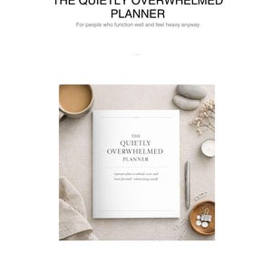 May include: A white planner titled "The Quietly Overwhelmed Planner" with text that reads "For people who function well and feel heavy anyway." The image includes a cup of coffee, stones, a candle, a pen, and paperclips.