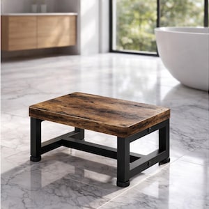 May include: A rectangular step stool with a brown, wood-look top and black metal legs. The stool has a sturdy design and is suitable for use in a bathroom or other areas where a step up is needed.