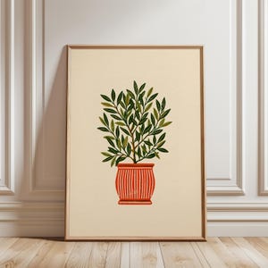 Pode incluir: Uma impressão de arte de parede emoldurada com uma ilustração estilizada de uma planta de folhas verdes num vaso laranja com riscas verticais. A planta tem numerosas folhas pontiagudas em vários tons de verde sobre um fundo bege claro.