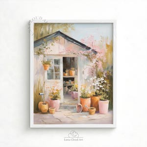 May include: A framed art print depicting a garden shed with a white exterior and a black roof. The scene features potted plants in pink and orange hues, rendered in a soft, impressionistic style. The artwork is signed "Luna Cloud Art".