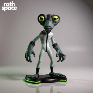 May include: A figurine of a Grey alien character with large yellow eyes, a white jumpsuit, and dark gray hands and feet. The figure stands on a black base with a green neon trim. The text "rath space" is in the upper left corner.