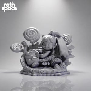 May include: A monochromatic gray resin figurine featuring a character with a high ponytail driving a small race car. The scene is decorated with large swirl lollipops and candy-themed elements. The text "rath space" appears in the top left corner.