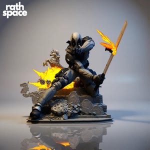 May include: A detailed statue of Deadpool in a dynamic pose, holding a flaming sword. The figure is clad in a gray and black suit, with a white mask. The base features a fiery explosion and a small carousel horse. The Rath Space logo is visible.