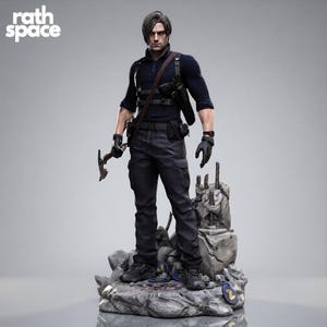 May include: A detailed collectible figurine of a male character with dark hair, wearing a navy blue long-sleeve shirt, dark tactical pants, and a shoulder holster. The figure holds a small metallic tool and stands on a rocky, debris-filled base.