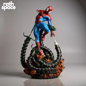 May include: A detailed figurine of Spider-Man in a dynamic pose, clad in his iconic red and blue suit. He is positioned atop a base featuring Doctor Octopus's mechanical arms. The base is a mix of brown and black, with the text "rath space" in white.