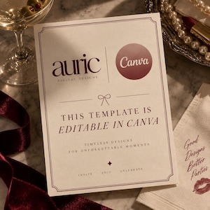 May include: A rectangular card with a cream background and dark red text that reads: auric DIGITAL DESIGNS, Canva, THIS TEMPLATE IS EDITABLE IN CANVA, TIMELESS DESIGNS FOR UNFORGETTABLE MOMENTS, INVITE &middot; EDIT &middot; CELEBRATE. The card features a thin border.