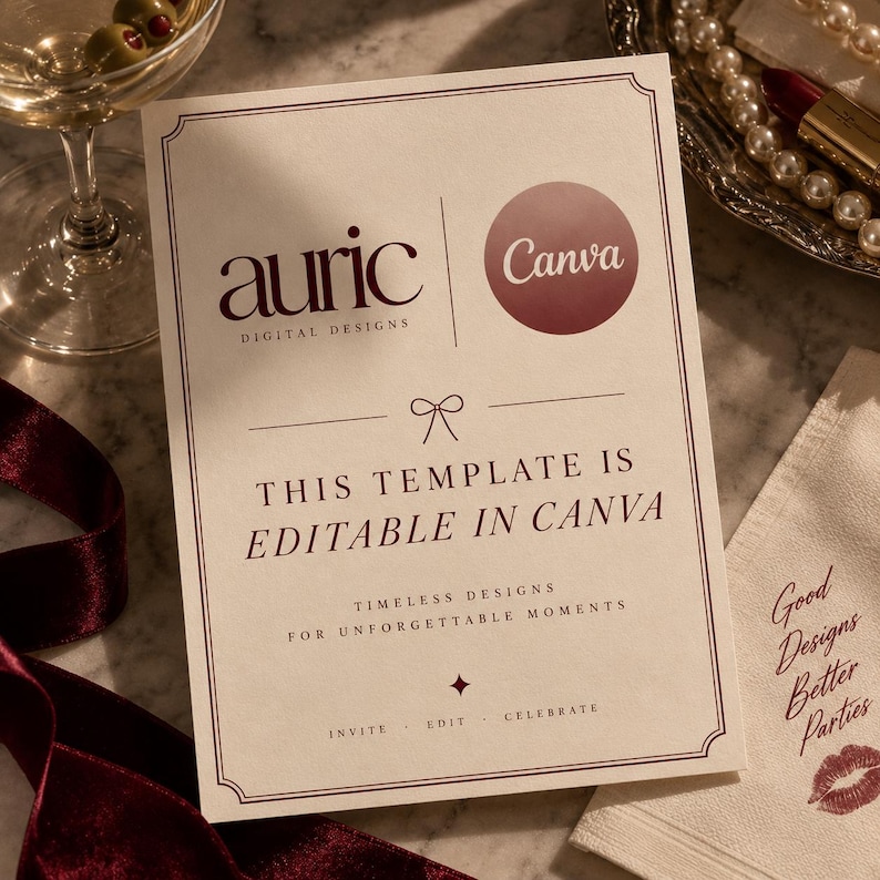 May include: A rectangular card with a cream background and dark red text that reads: auric DIGITAL DESIGNS, Canva, THIS TEMPLATE IS EDITABLE IN CANVA, TIMELESS DESIGNS FOR UNFORGETTABLE MOMENTS, INVITE &middot; EDIT &middot; CELEBRATE. The card features a thin border.
