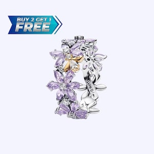 May include: A floral ring with purple and gold accents. The ring features a design of stylized flowers with purple petals and clear gemstone accents. The ring is made of silver and has the text "MET" and "S925 ALE" engraved on it.