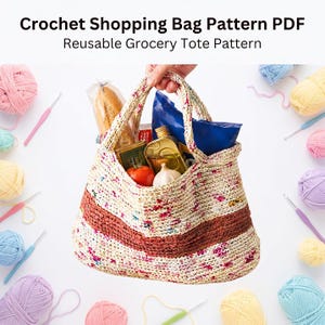 May include: A crochet shopping bag pattern PDF for a reusable grocery tote. The bag is cream-colored with a wide horizontal rust-colored stripe and multicolored flecks, filled with a loaf of bread, a bottle of oil, a tomato, and garlic.