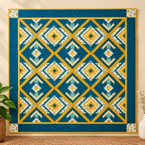 May include: A square quilt featuring a geometric pattern of diamonds and triangles in deep teal, mustard yellow, and cream. The design includes floral accents in the corners and borders, with visible diagonal stitching throughout the fabric surface.