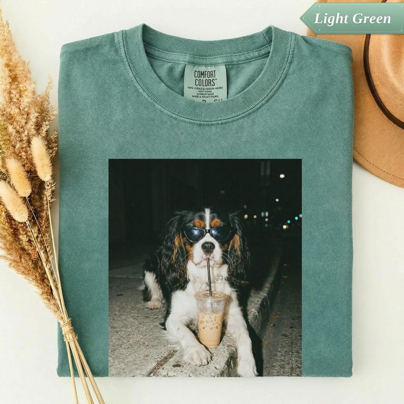 T-shirt with dog wearing sunglasses drinking iced coffee.