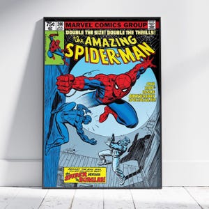 May include: A framed comic book cover of The Amazing Spider-Man. The cover features Spider-Man in a dynamic pose, with text that reads "DOUBLE THE SIZE! DOUBLE THE THRILLS!" and "SPIDER VERSUS THE BURGLAR!"