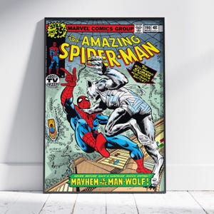 May include: Framed comic book cover depicting Spider-Man in a fight with Man-Wolf. The artwork is colourful, with blue, red, and yellow tones. Text includes "The Amazing Spider-Man" and "Mayhem is the Man-Wolf!" A classic comic book illustration.