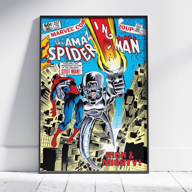 May include: Framed vintage comic book cover art featuring Spider-Man and Stilt-Man. The artwork has a blue, yellow, and red colour scheme, with text that reads "The Amazing Spider-Man" and "High & Mighty!"