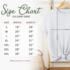 A light gray Gildan 5000 t-shirt size chart with measurements in inches. The chart lists sizes S to 4XL, with corresponding width and length measurements. The text "Size Chart" is at the top, with "GILDAN 5000" below it.
