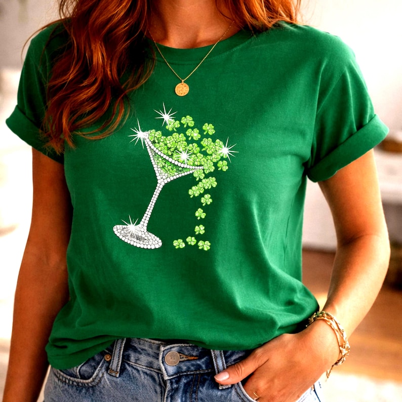 Woman wearing a green T-shirt with a rhinestone-style martini glass design decorated with shamrock clovers.