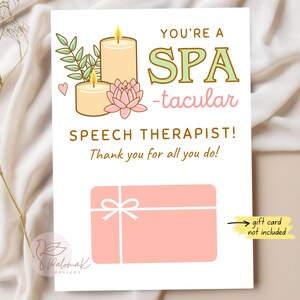 May include: A white card with the text "YOU'RE A SPA-tacular SPEECH THERAPIST! Thank you for all you do!" features illustrations of candles, a lotus flower, and a gift card. The card also includes the text "gift card not included."