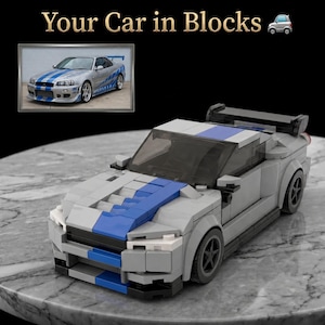 May include: A gray and blue block-built model car featuring a rear spoiler, tinted windshield, and a front bumper design. The text Your Car in Blocks is displayed above a small inset photograph of a silver sports car with blue racing stripes.