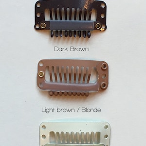 May include: Three hair clips in different colors: dark brown, light brown/blonde, and platinum blonde. The clips are designed to match the color of your hair roots.