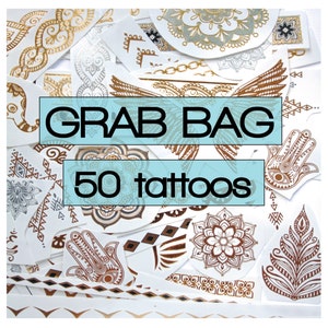 May include: A collection of 50 gold and brown temporary tattoos on a white background. The tattoos feature various designs, including geometric patterns, mandalas, and hand-shaped symbols. The text "Grab Bag 50 tattoos" is printed on the image.