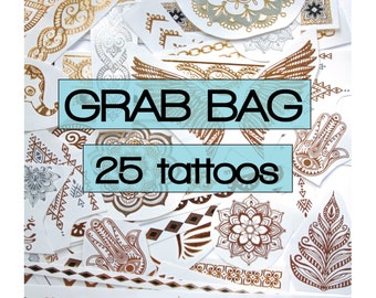 May include: A collection of 25 temporary tattoos with various designs, including henna-style patterns, mandalas, and geometric shapes. The tattoos are in gold, silver, and brown tones, with the words "Grab Bag" and "25 tattoos" in a blue box.