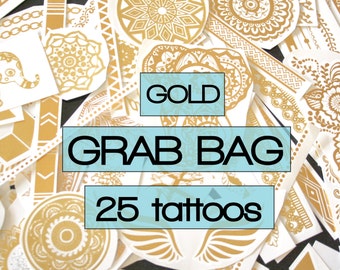 May include: A grab bag of 25 gold temporary tattoos. The tattoos are a mix of different designs, including geometric shapes, mandalas, and floral patterns.