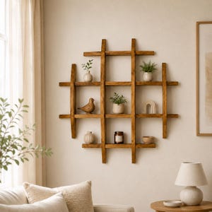 May include: A wooden wall shelf with a grid design, filled with decorative items. The shelf is stained a warm brown and holds small potted plants, a ceramic bird, and other decor. The shelf is mounted on a neutral-colored wall.