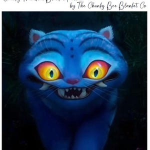 May include: A blue cartoon tiger with large yellow and orange eyes and a wide grin. The image includes the text "K-Pop Derpy Tiger" and "Chunky Handknit Blanket Pattern by The Chunky Bee Blanket Co."