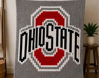 May include: Gray knitted blanket featuring the Ohio State logo in red, white, and black. The blanket has a striped border in red and white. The word "OHIO STATE" is prominently displayed in bold, black letters.