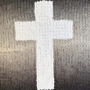 May include: A white, chunky-knit cross design on an ombre blanket, transitioning from dark gray to light gray. The text "Ombre Cross" is at the top, with "Chunky Handknit Blanket Pattern" and "by The Chunky Bee Blanket Co." at the bottom.