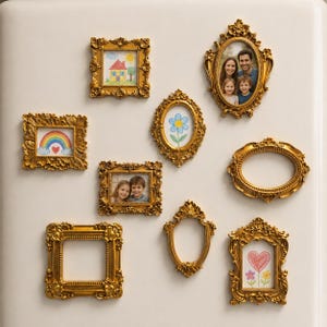 May include: A collection of ornate, gold-colored picture frames in various shapes and sizes. Some frames contain drawings of a house, a rainbow, a flower, and a heart. Other frames hold photographs of a family and two children.