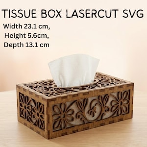 May include: Laser-cut wooden tissue box with floral design. The box is 23.1 cm wide, 5.6 cm high, and 13.1 cm deep. White tissues are visible. The text "TISSUE BOX LASERCUT SVG" is at the top.