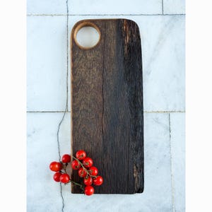 May include: A handmade wooden sign displaying the word "Welcome" in a whimsical font. The white-painted sign has a distressed finish and a small heart detail. Suitable for indoor or outdoor display.