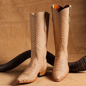 May include: A set of three ceramic nesting bowls in graduating sizes. The bowls have a speckled, matte finish in cream, light grey, and dark grey. The largest bowl is approx. 20 cm in diameter.