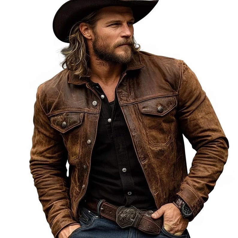 May include: A brown leather jacket with a distressed finish, featuring two chest pockets and button closures. The jacket is worn over a black shirt and paired with a brown belt with a decorative buckle. A brown cowboy hat completes the look.