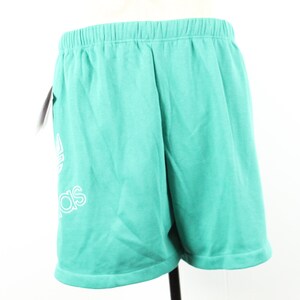 May include: Teal athletic shorts with a white Adidas logo.
