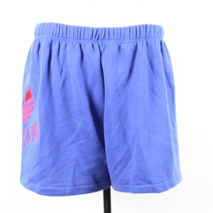 May include: Blue athletic shorts with a pink and red Adidas logo.
