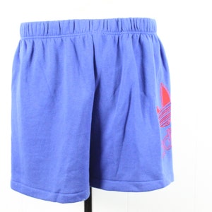 May include: Blue athletic shorts with a red Adidas logo on the right leg.