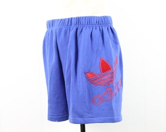 May include: Blue athletic shorts with a red Adidas logo embroidered on the right leg.