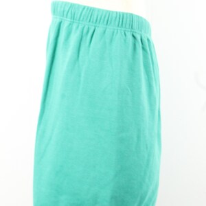 May include: A pair of teal blue shorts with an elastic waistband.